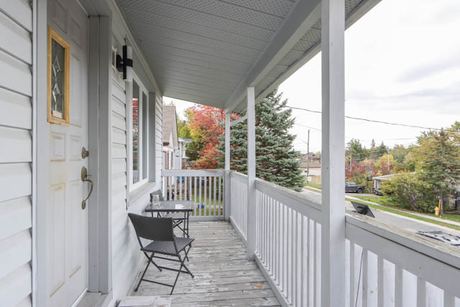 Covered front porch with seating and a view of the street