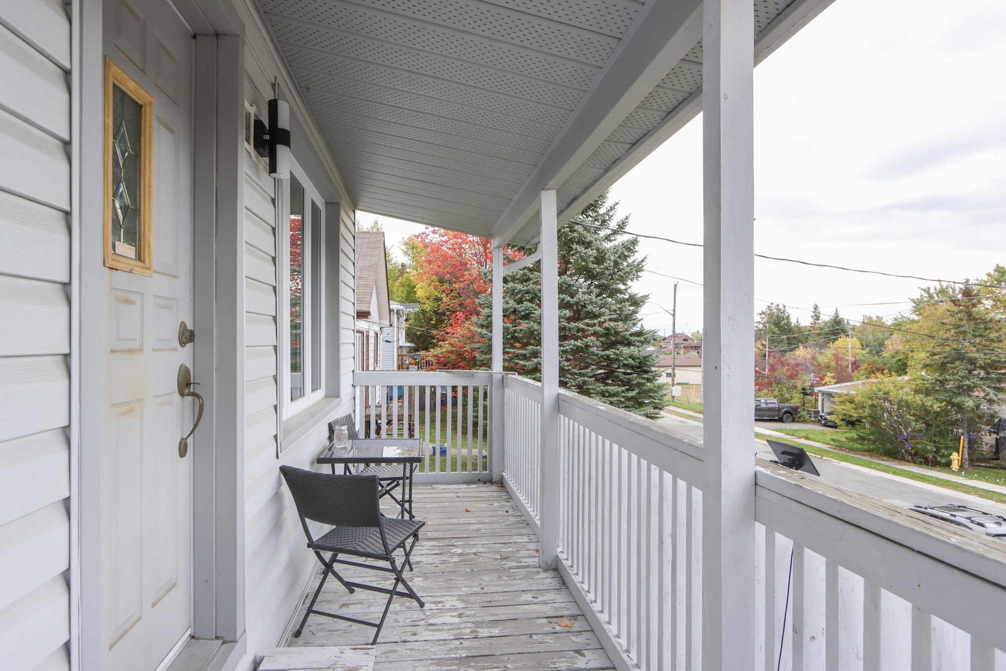 Covered front porch with seating and a view of the street